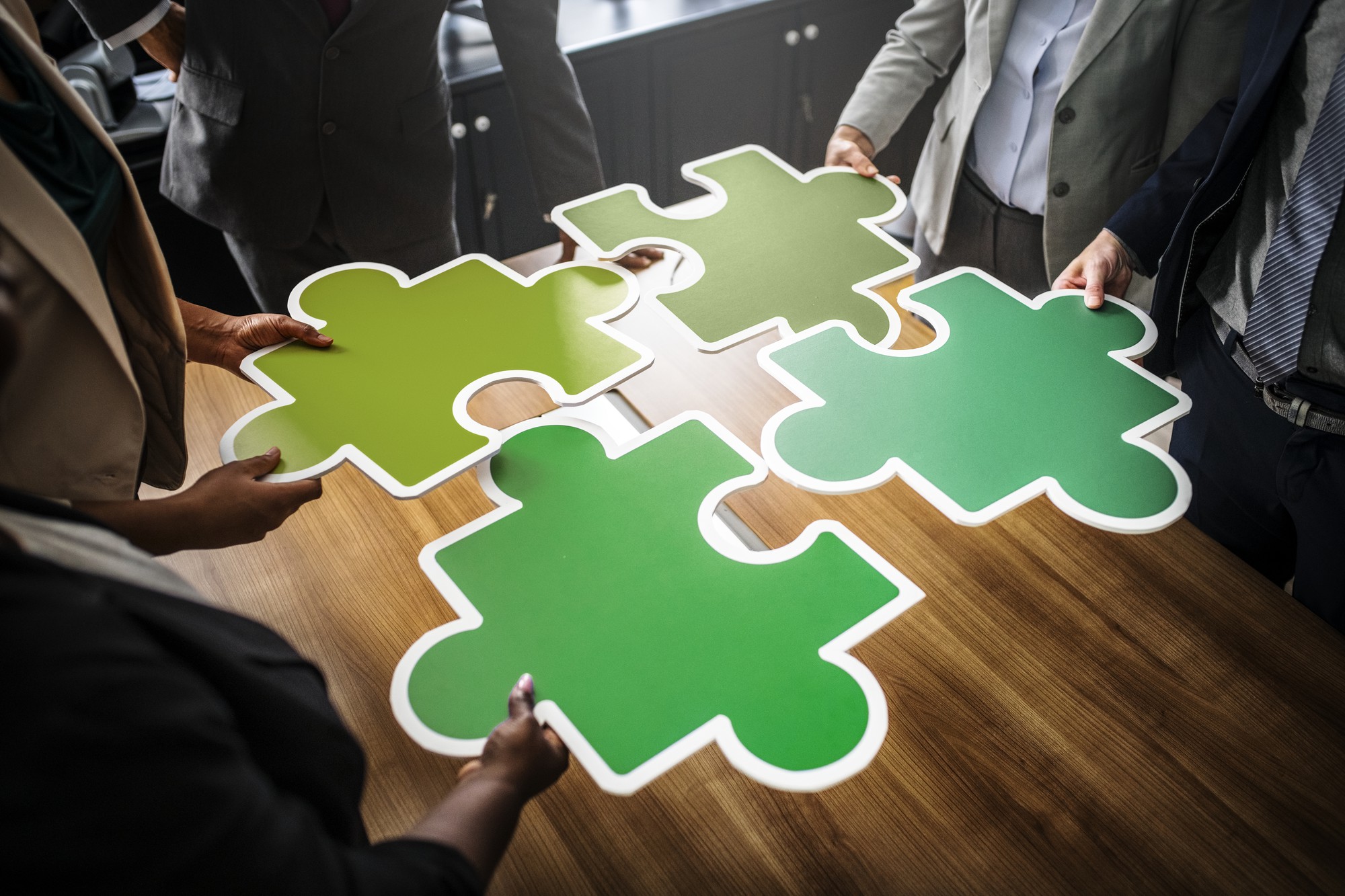 business-people-connecting-puzzle-pieces