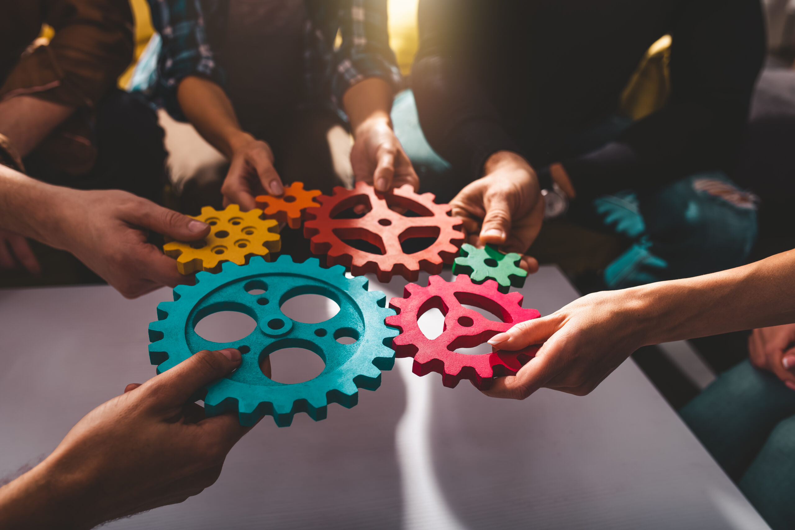 Business team connect pieces of gears. Teamwork and integration concept